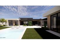 Modern home featuring a pristine pool, lounge chairs, and a well-manicured lawn, perfect for outdoor relaxation at 8618 E Irish Hunter Trl, Scottsdale, AZ 85258