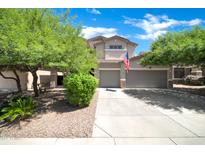 Beautiful two-story home with a three-car garage and well-maintained landscaping at 10430 W Los Gatos Dr, Peoria, AZ 85383