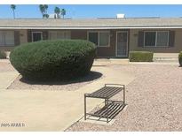 Charming single-story home featuring a landscaped front yard and a cozy bench for relaxing outdoors at 10520 W Coggins Dr, Sun City, AZ 85351