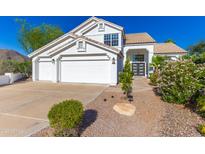 Charming two-story home featuring a three-car garage and beautifully landscaped front yard at 11089 N 130Th Pl, Scottsdale, AZ 85259