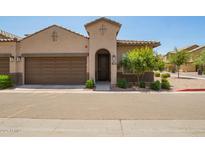 Inviting beige two-story home featuring a tile roof, two-car garage, and well-maintained landscaping at 1255 N Arizona Ave # 1300, Chandler, AZ 85225