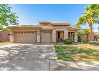 Charming single-story home featuring a three-car garage and a well-manicured front yard at 1474 E Locust Dr, Chandler, AZ 85286