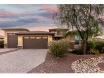 Charming home featuring a three-car garage and desert landscaping, enhancing its curb appeal at 18108 W Cassia Way, Goodyear, AZ 85338