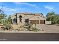 Charming single-story home features a three-car garage and desert landscaping at 26475 N Wrangler Rd, Scottsdale, AZ 85255