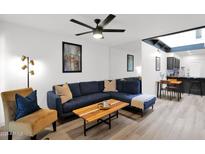 Cozy living room featuring a comfortable blue sofa, stylish decor, and bright lighting at 2946 N 14Th St # 37, Phoenix, AZ 85014