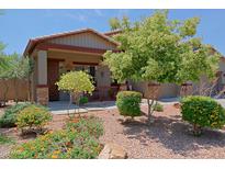 Charming single-story home featuring a well-manicured front yard with colorful desert landscaping at 4609 W Challenger Trl, New River, AZ 85087