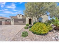 Charming single-story home with a two-car garage, desert landscaping, and a welcoming front entrance at 4866 N 185-Th Dr, Goodyear, AZ 85395