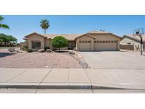 Charming home featuring low maintenance landscaping, tile roof, and a spacious three car garage at 6645 E Preston St, Mesa, AZ 85215