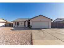 Charming single-story home showcasing a two-car garage, low-maintenance landscaping, and neutral color palette at 9009 W Butler Dr, Peoria, AZ 85345