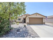 Charming single-story home featuring a well-maintained yard and attached two-car garage at 941 E Desert Moon Trl, San Tan Valley, AZ 85143