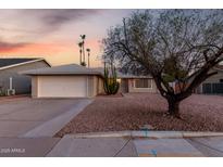Charming single-story home featuring desert landscaping and a two-car garage on a spacious lot at 1055 E Ingram St, Mesa, AZ 85203