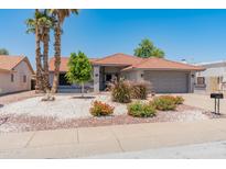 Charming single-story home featuring desert landscaping, a tile roof, and a two-car garage at 14420 N 44Th Dr, Glendale, AZ 85306