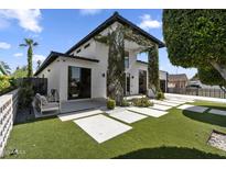 Stunning two-story modern home featuring an artifical lawn, tasteful vegetation and a beautifully designed front walkway at 1807 E Campbell Ave, Phoenix, AZ 85016