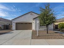 Charming single-story home featuring a well-maintained front yard and an attached two-car garage at 21120 E Creekside Dr, Queen Creek, AZ 85142