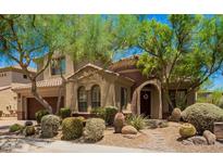 Charming single Gathering home with beautiful desert landscaping, mature trees, and a tile roof in a sunny setting at 22903 N 39Th Ter, Phoenix, AZ 85050