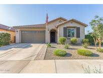 Charming single-story home with manicured landscaping, neutral stucco, and a welcoming front porch at 22920 E Indiana Ave, Queen Creek, AZ 85142