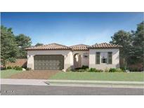 Charming single-story home with a tile roof, arched entryway, and attached two-car garage, surrounded by a well-maintained lawn at 23008 E Roundup Way, Queen Creek, AZ 85142