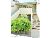 Condo exterior featuring a tidy garden, neutral colors, and easy access stairs at 30 E Brown Rd # 2113, Mesa, AZ 85201