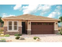 Charming single-story home featuring a two-car garage, brick accents, and a well-maintained, low-water landscape at 39985 W Anne Ln, Maricopa, AZ 85138