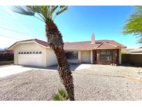 Charming single-story home with well-maintained landscaping, desert rock, and a two-car garage at 4008 E Knox Rd, Phoenix, AZ 85044
