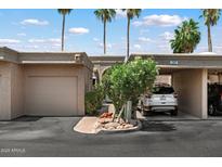 Charming single-story home with a one-car garage and a carport nestled beneath swaying palm trees at 4015 N 78Th St # 135, Scottsdale, AZ 85251
