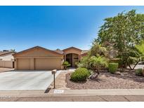 Charming single-story home with a three-car garage and desert landscaping at 4345 E Annette Dr, Phoenix, AZ 85032