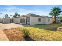 Charming single-story home features a well-maintained front yard, mature palm trees, and a neutral color palette at 4400 N 20Th St, Phoenix, AZ 85016