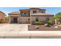 Stunning two-story home featuring a desert landscape, balcony, and spacious driveway at 4423 W Lodge Dr, Laveen, AZ 85339