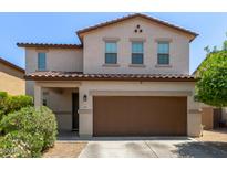 Inviting two-story home with a covered entryway and a spacious two-car garage at 4807 W St Anne Ave, Laveen, AZ 85339