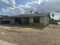 Single story home with gravel front yard and covered entryway offers classic curb appeal at 564 N Santa Anna St, Mesa, AZ 85201