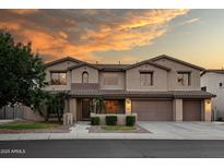 Gorgeous two-story home featuring well manicured landscaping, a two car garage, and beautiful desert sunset skies at 7156 S Forest Ave, Gilbert, AZ 85298