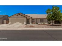 Charming single-story home featuring a well-maintained front yard, two-car garage, and inviting curb appeal at 10852 E Contessa St, Mesa, AZ 85207