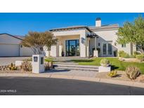 Elegant stucco home featuring a landscaped front yard and a welcoming entrance with modern design elements at 11250 W Prospector Dr, Queen Creek, AZ 85144