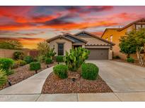 Charming single-story home featuring desert landscaping, a two-car garage and a cozy entrance at 12062 W Duane Ln, Peoria, AZ 85383