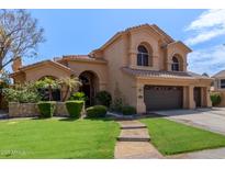 Charming home boasts a tile roof, lush landscaping, and a two-car garage at 1211 E Desert Flower Ln, Phoenix, AZ 85048