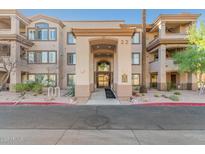 Inviting condo entrance showcasing a grand archway, desert landscaping, and a well-maintained exterior in a vibrant community at 14000 N 94Th N St # 1129, Scottsdale, AZ 85260