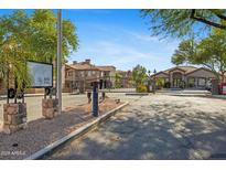Gated community entrance featuring desert landscaping and well-maintained buildings under a clear blue sky at 14000 N 94Th St # 3198, Scottsdale, AZ 85260