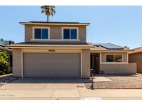 Charming two-story home featuring an attached garage, solar panels, and well-maintained landscaping at 14235 N 26Th Ln, Phoenix, AZ 85023