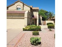 Charming two-story home with a two-car garage and well-maintained desert landscaping at 1606 N Apache Dr, Chandler, AZ 85244