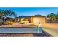 Charming brick home featuring a well-kept yard and a two-car garage at 16602 N 66Th St, Scottsdale, AZ 85254