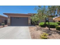 Single-story home with a two-car garage and desert landscaping at 18617 W Williams St, Goodyear, AZ 85338