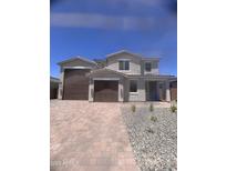 Charming two-story home showcasing a spacious three-car garage and a welcoming facade with manicured landscaping at 18778 E Panchito Dr, Gold Canyon, AZ 85118