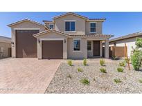 Inviting two-story home with a two-car garage, low-maintenance landscaping, and a welcoming front porch entry at 18778 E Panchito Dr, Gold Canyon, AZ 85118