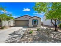 Charming single-story home with a well-manicured front yard, desert landscaping, and a two-car garage at 25657 W Beth Dr, Buckeye, AZ 85326