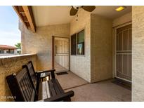 Inviting outdoor patio features a cozy bench and a secure entrance to the home at 4150 E Cactus Rd # 205, Phoenix, AZ 85032
