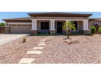 Charming single-story home with a desert landscape, stone pathway, and a welcoming covered porch at 465 E Frances Ln, Gilbert, AZ 85295