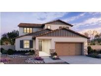 Two-story home showcasing desert landscaping, a two-car garage, neutral color palette and a covered entryway at 5439 S 251St Dr, Buckeye, AZ 85326