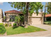 Charming single-story home featuring a well-maintained lawn and a two-car garage at 6611 N 79Th Pl, Scottsdale, AZ 85250