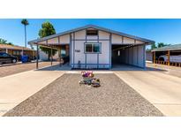Charming home featuring a carport, lovely desert landscaping, and an inviting entrance at 7343 E Juanita Ave, Mesa, AZ 85209