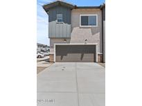 Exterior view of a two-car garage with neutral paint and a concrete driveway at 7427 S 75Th Ln, Laveen, AZ 85339